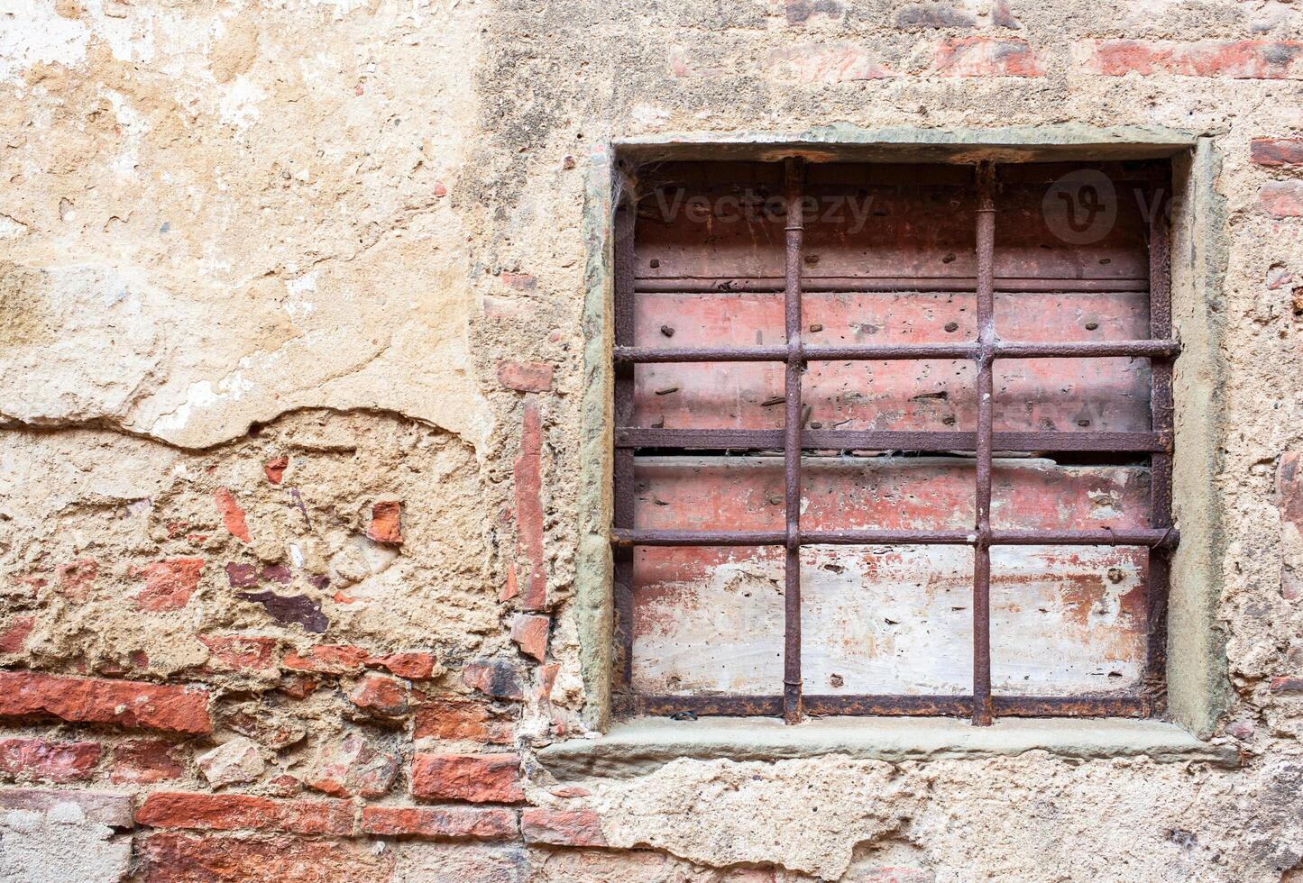 Old window with iron gratings photo