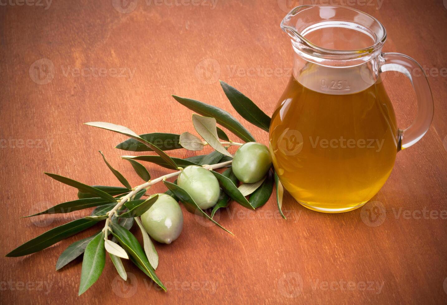 Olives and a bottle of olive oil photo