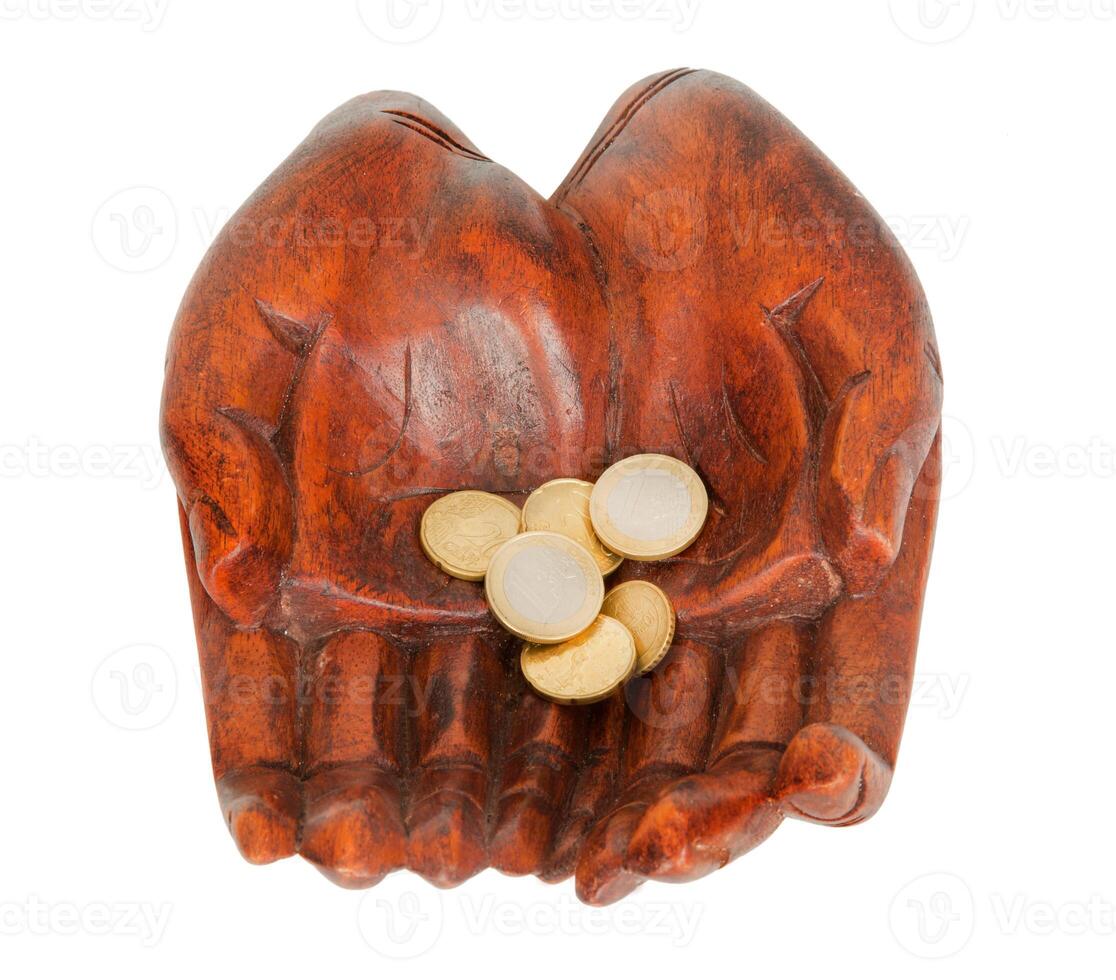 Wooden hands with euro coins photo
