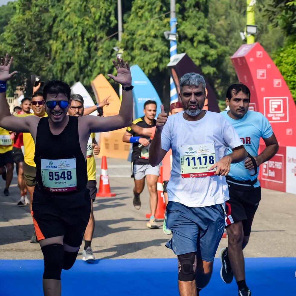 New Delhi, India - October 15 2023 - Vedanta Delhi Half Marathon race after covid in which marathon participants about to cross the finish line, Delhi Half Marathon 2023 photo