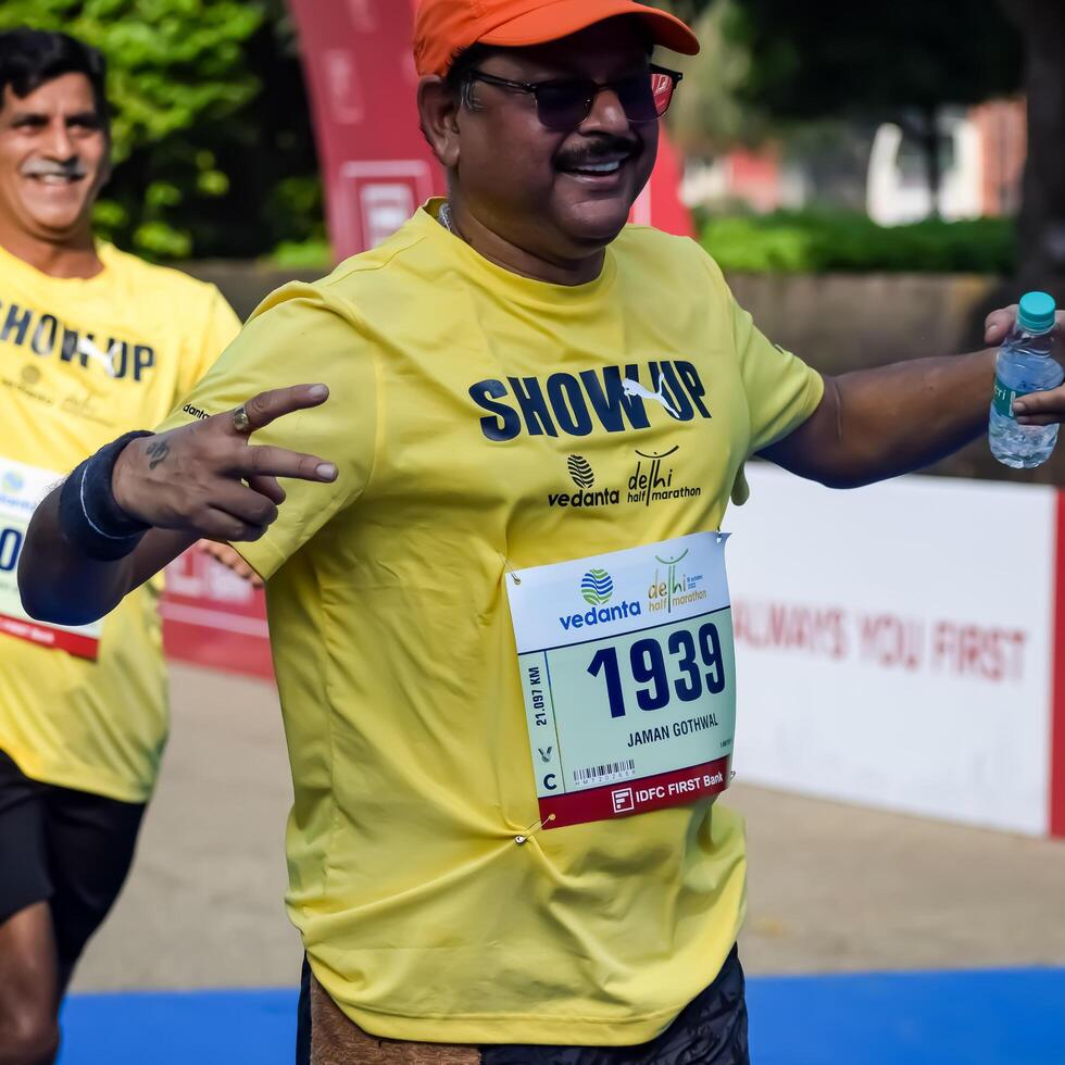 New Delhi, India - October 15 2023 - Vedanta Delhi Half Marathon race after covid in which marathon participants about to cross the finish line, Delhi Half Marathon 2023 photo