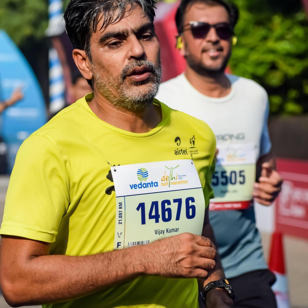 New Delhi, India - October 15 2023 - Vedanta Delhi Half Marathon race after covid in which marathon participants about to cross the finish line, Delhi Half Marathon 2023 photo