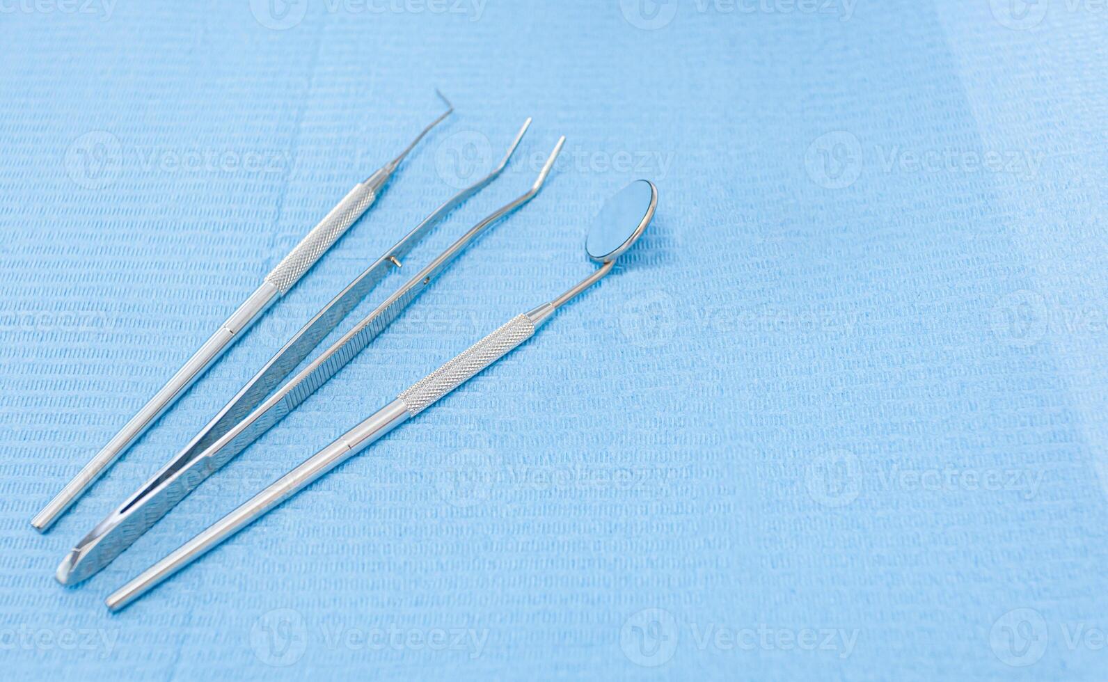 Dentist's tools on light blue background photo