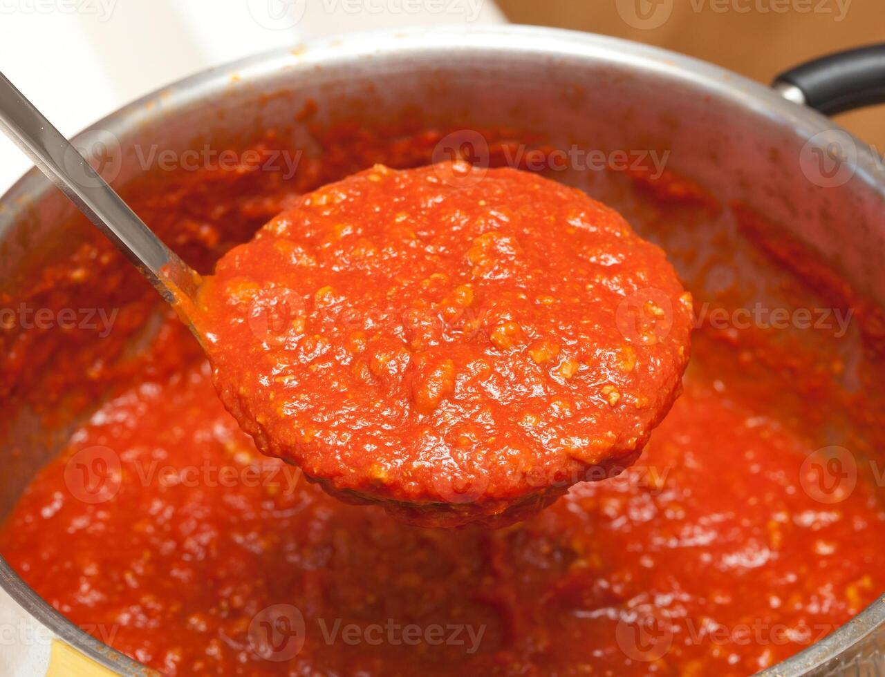 Ladle with bolognese sauce. photo