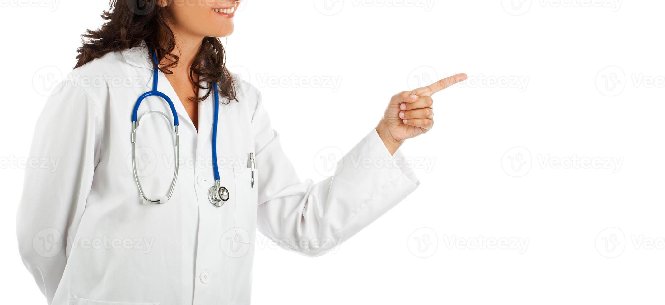 Female doctor pointing on empty white background. photo