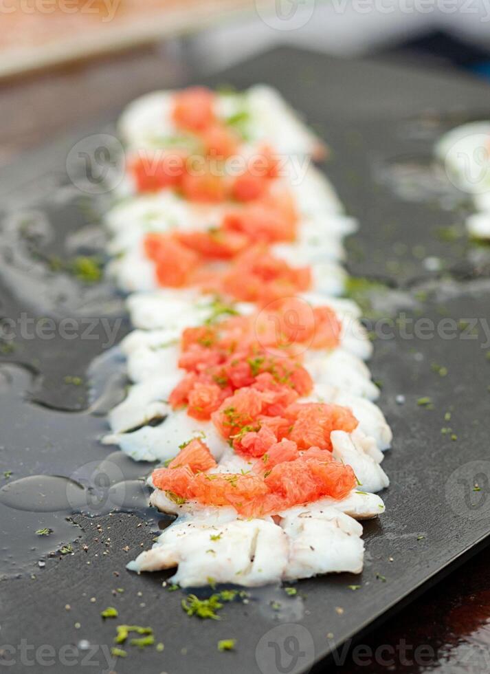 Branzino Fish fillet with tomatoes photo