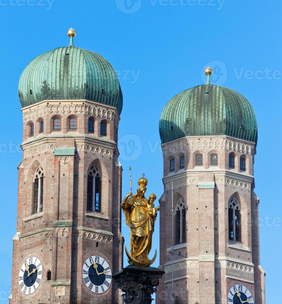 The golden sculpture of Saint Mary and the Church of Our Lady photo