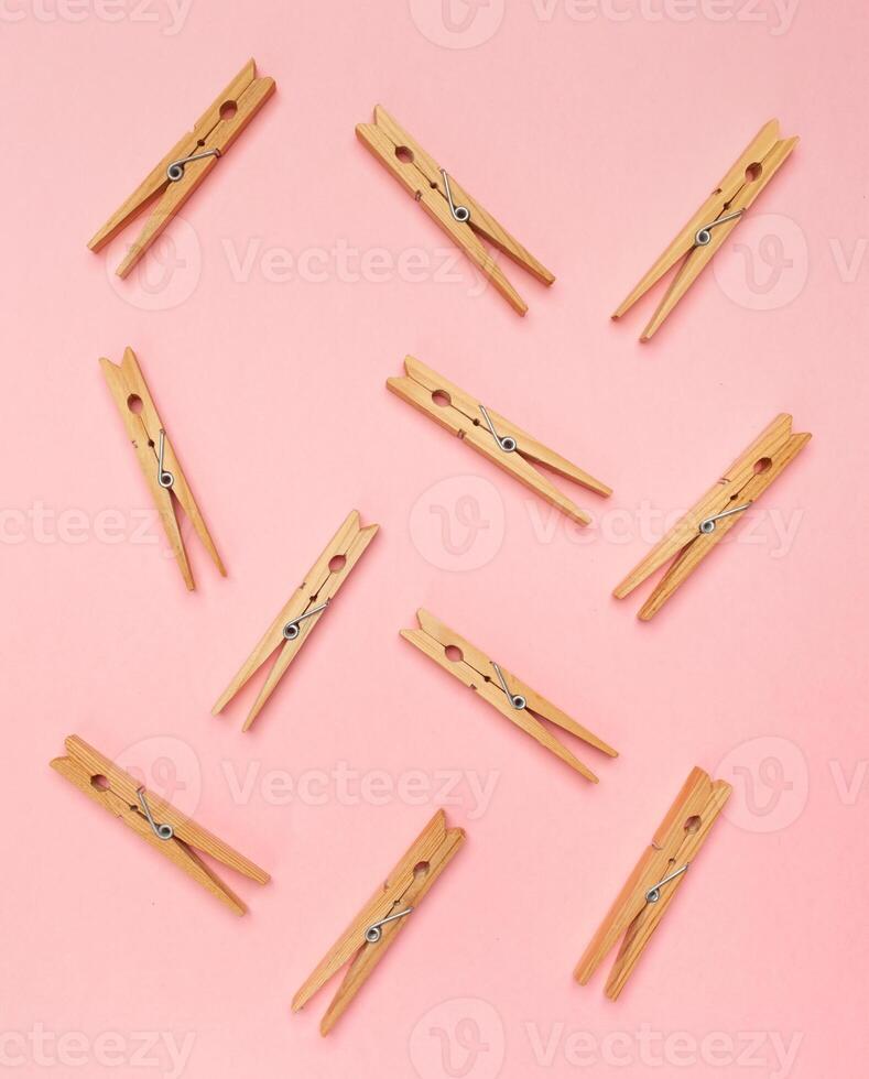 Clothes pins on a pink background photo