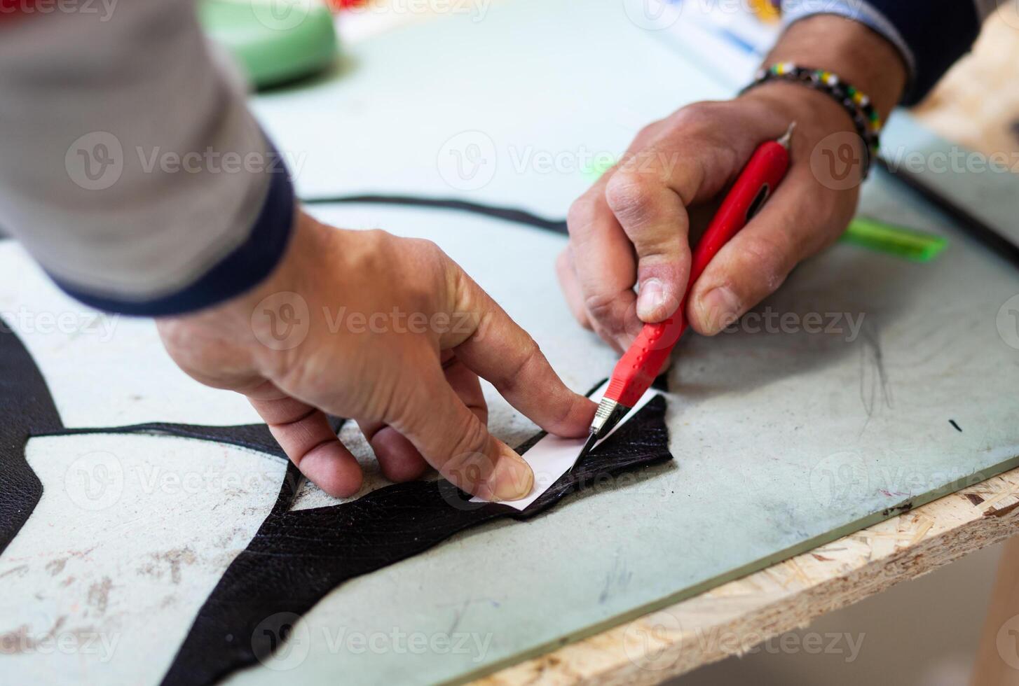 Shoe designer working with leather. photo