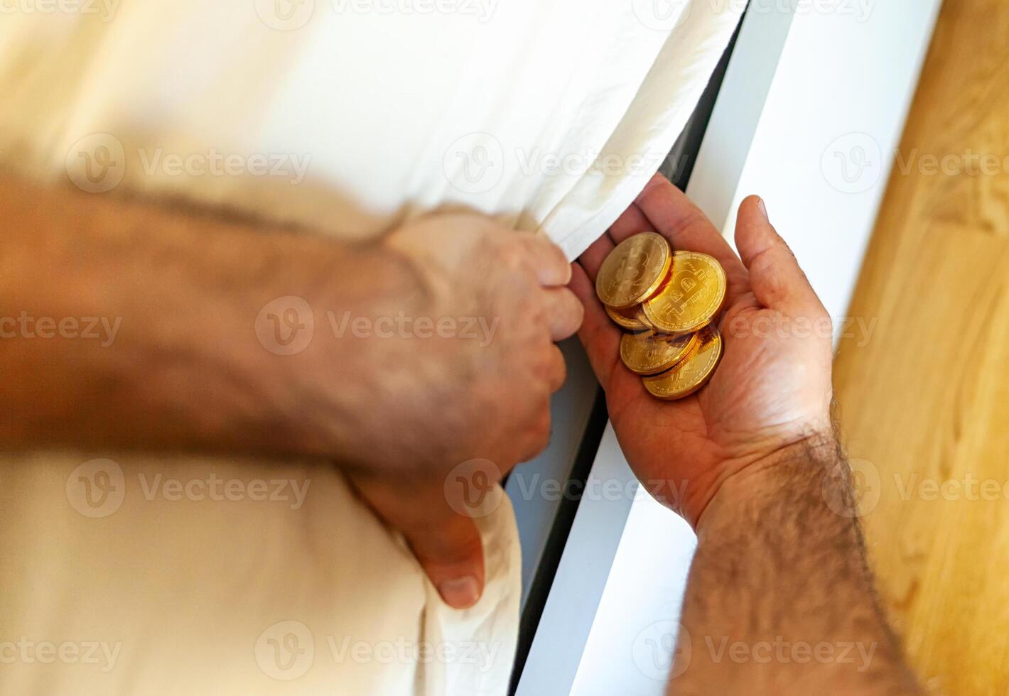 Bitcoin coins hidden under the mattress. photo