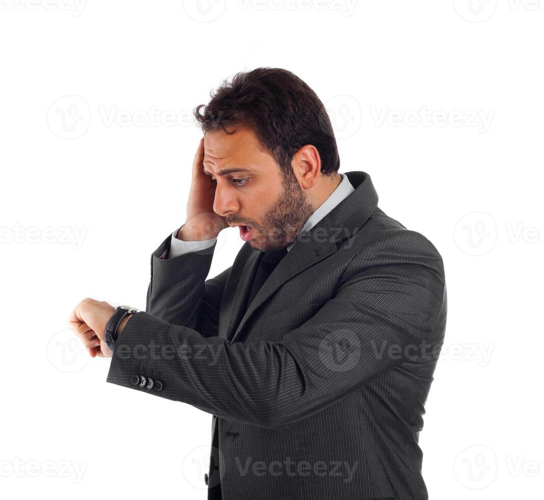 a man in a suit is looking at his watch photo