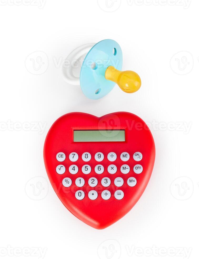 Calculator heart shaped and pacifier. photo