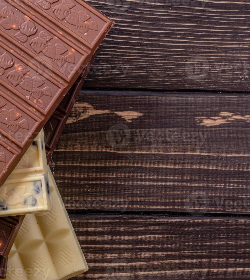 Chocolate bar pieces. Background with chocolate. Sweet food photo concept.