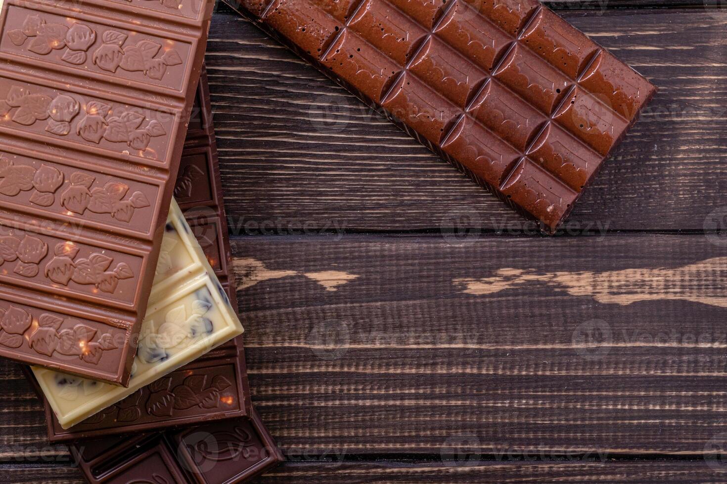 Chocolate bar pieces. Background with chocolate. Sweet food photo concept.