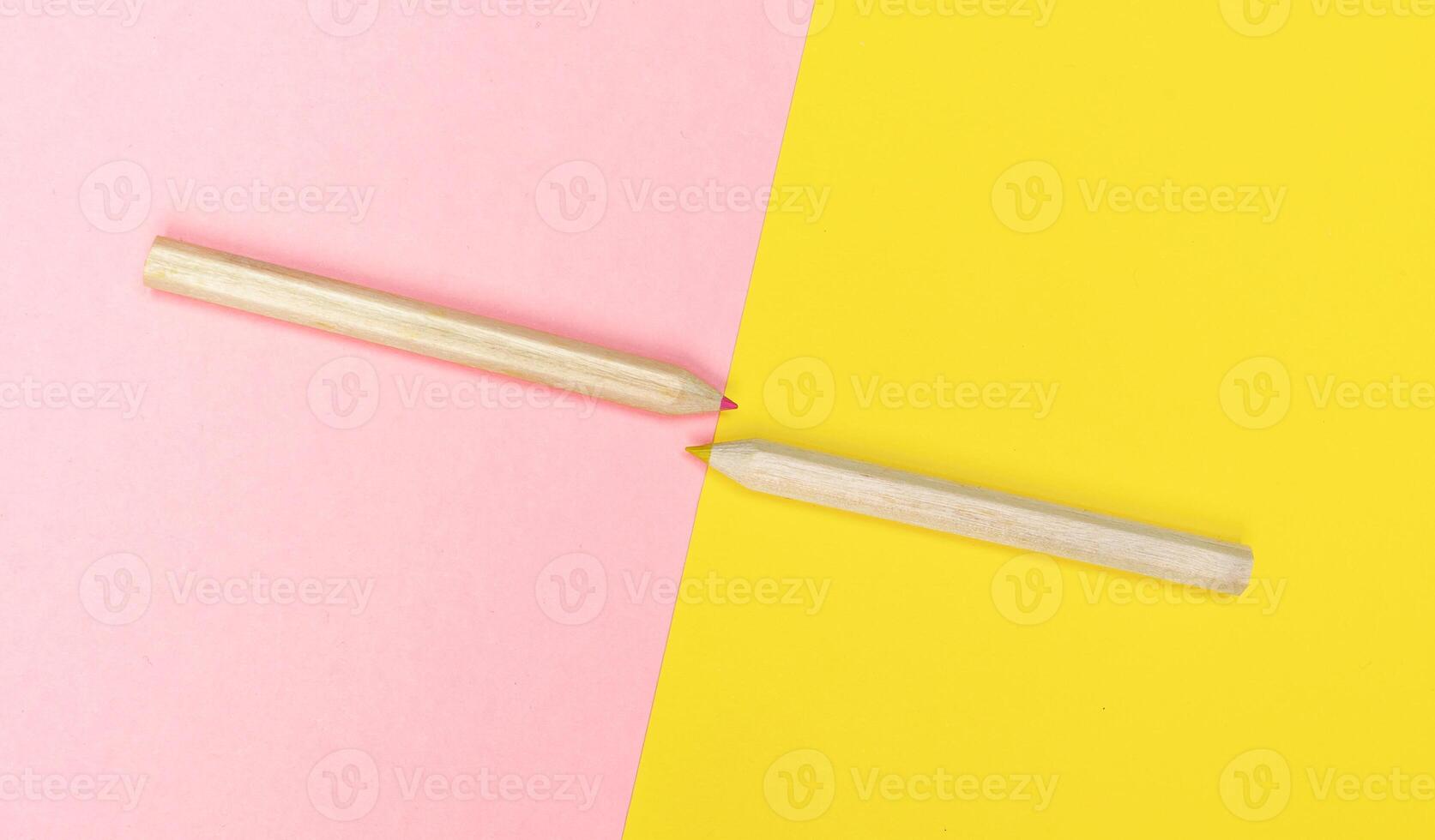 Colored pencils on yellow and pink background. photo