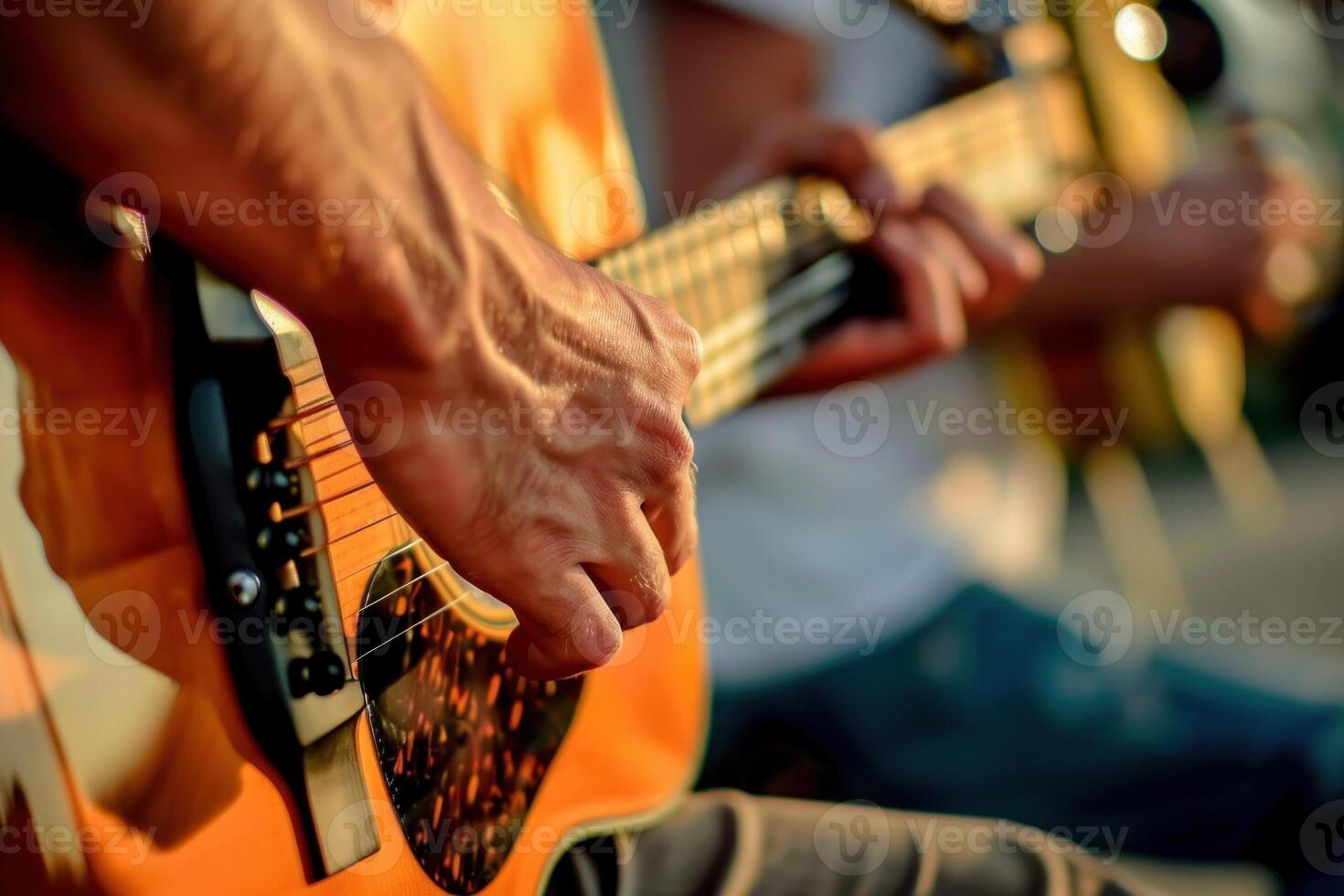 A man is playing a guitar with his hand on the neck photo