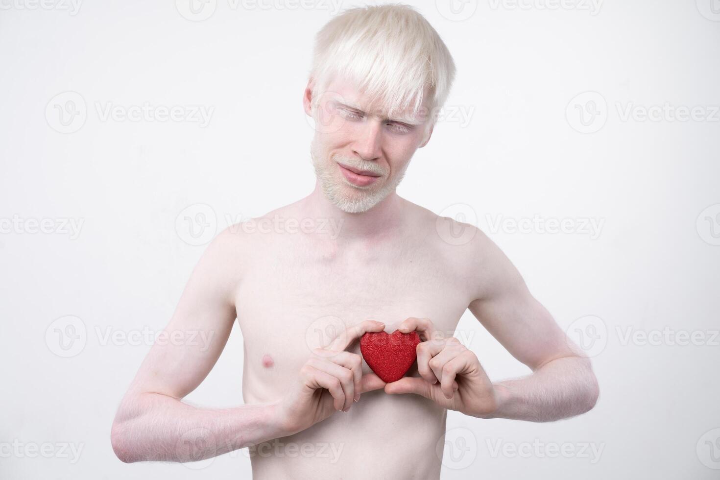 portrait of an albino man in studio dressed t-shirt isolated on a white background. abnormal deviations. unusual appearance photo