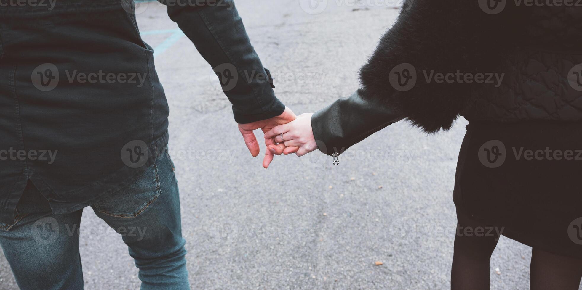 Closeup of loving couple holding hands photo