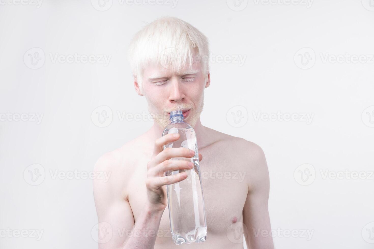 portrait of an albino man in studio dressed t-shirt isolated on a white background. abnormal deviations. unusual appearance photo