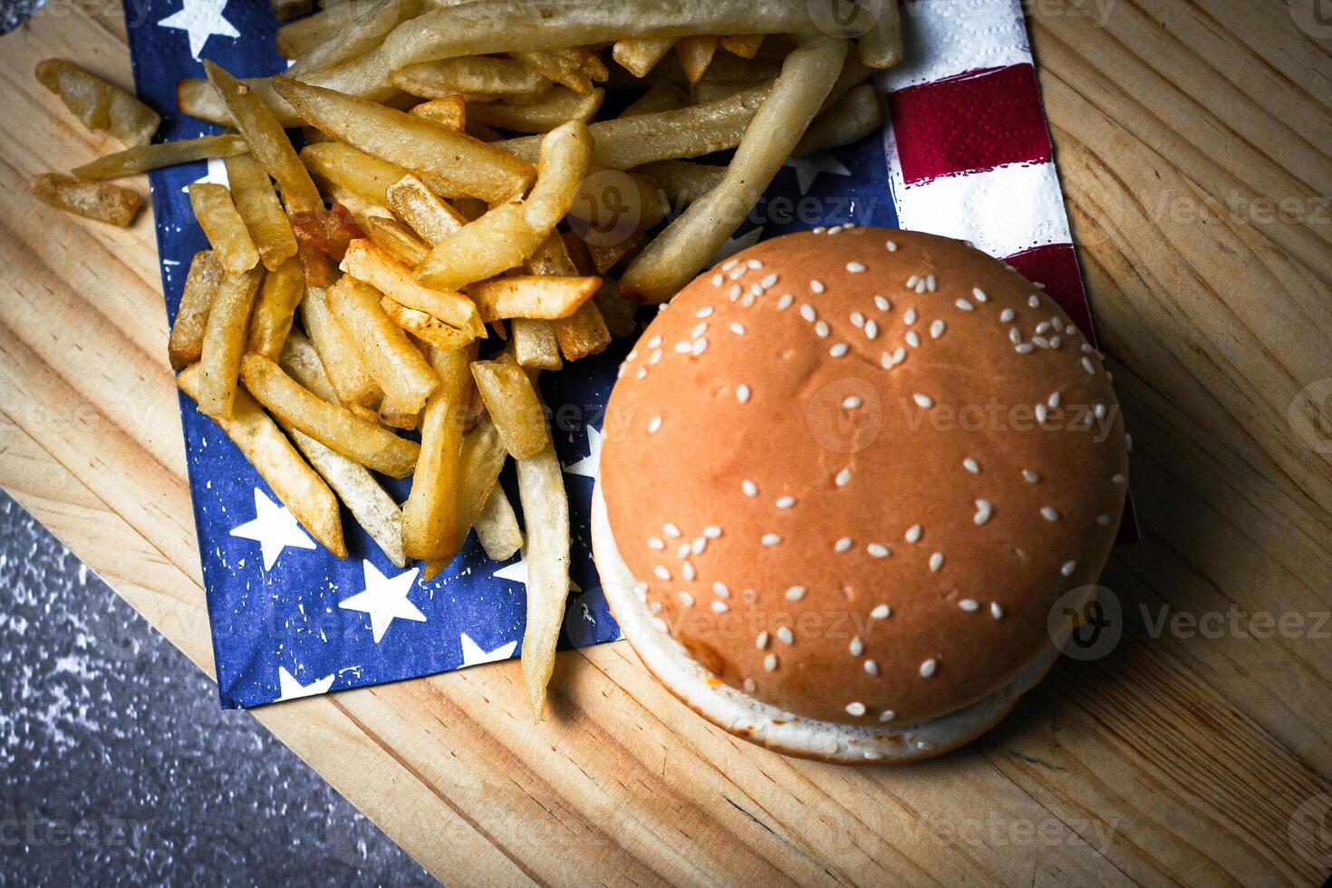 Cheese burger - American cheese burger with Golden French fries on wooden board photo