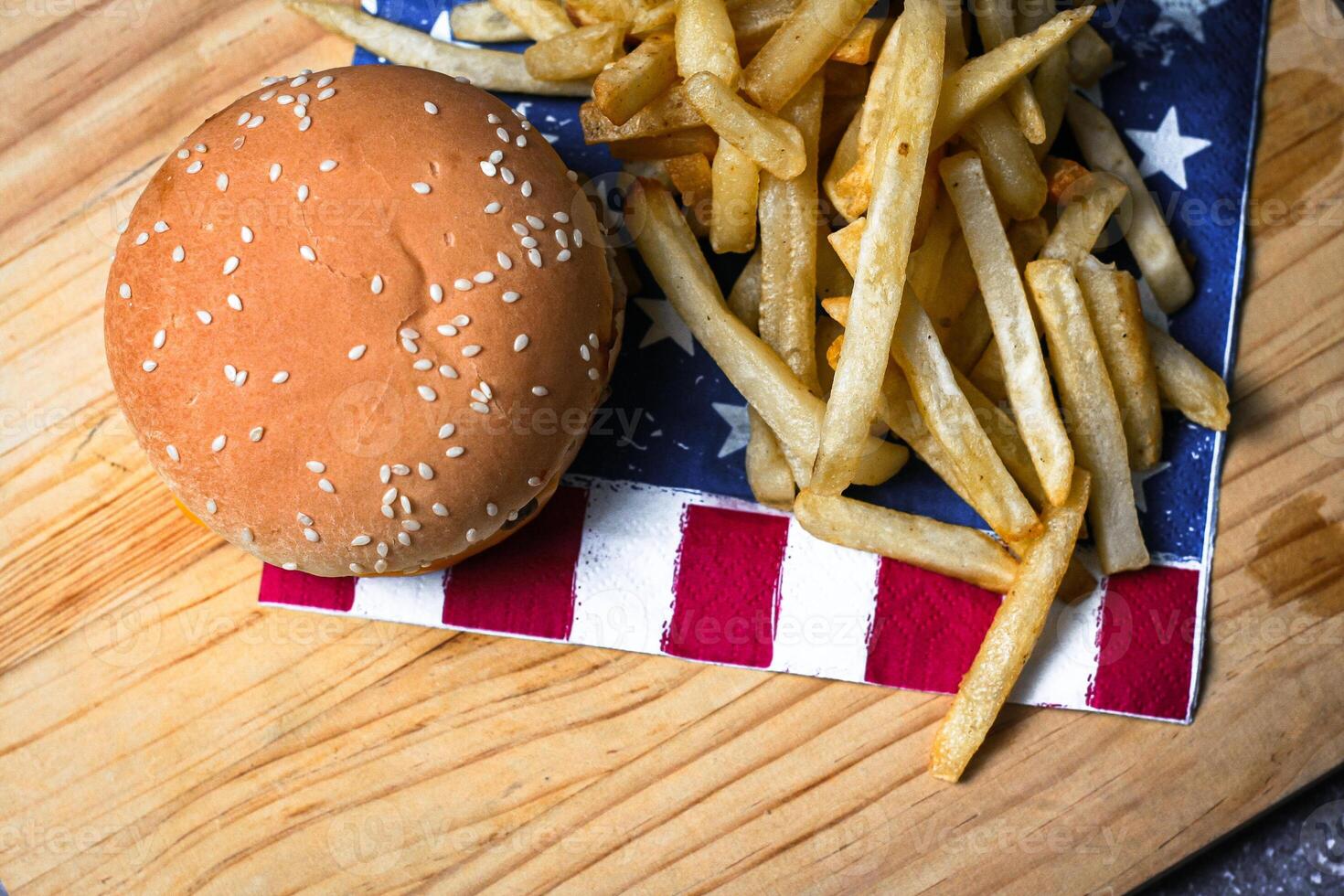 Cheese burger - American cheese burger with Golden French fries on wooden board photo