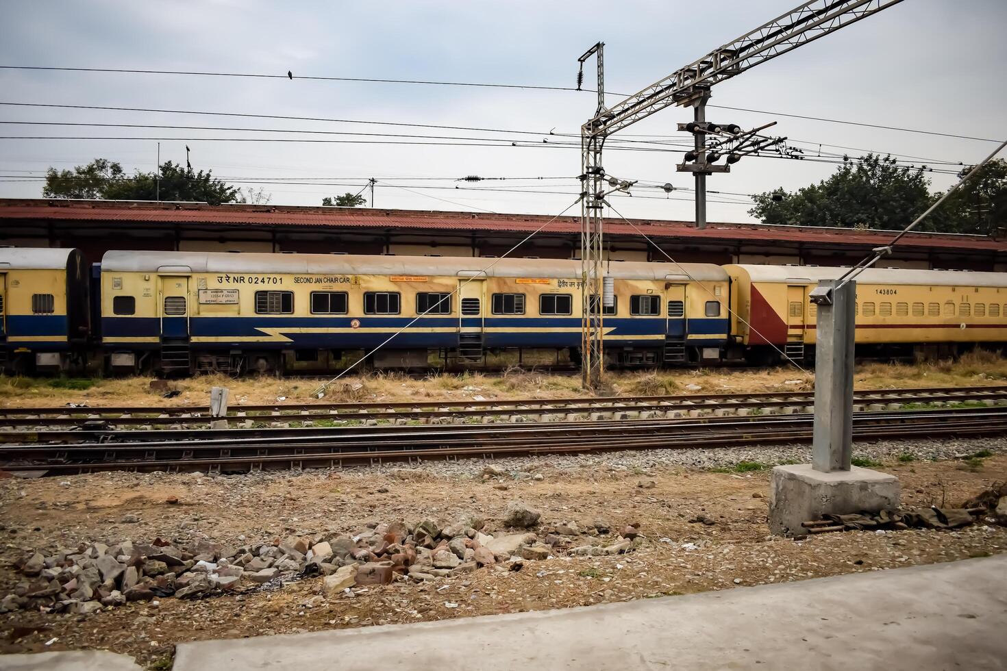 Amritsar, India, February 03 2024 - Indian railway train at Amritsar railway station platform during morning time, Colourful train at Amritsar, Punjab railway station photo