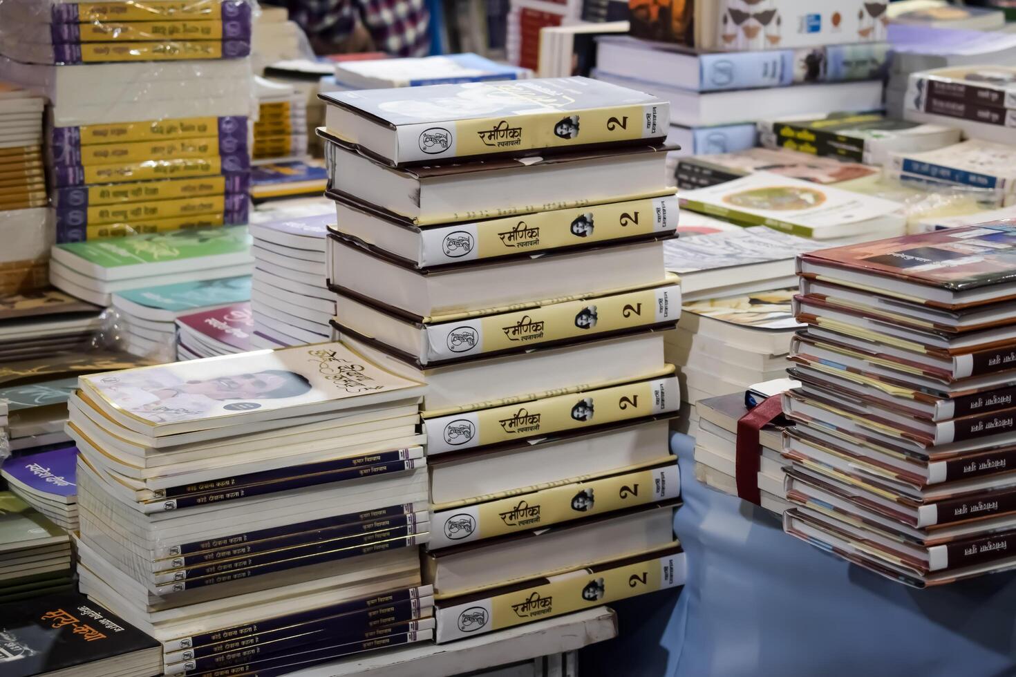 New Delhi, India, February 17 2024 - Variety of Books on shelf inside a book-stall at Delhi International Book Fair, Selection of books on display in Annual Book Fair at Bharat Mandapam complex photo
