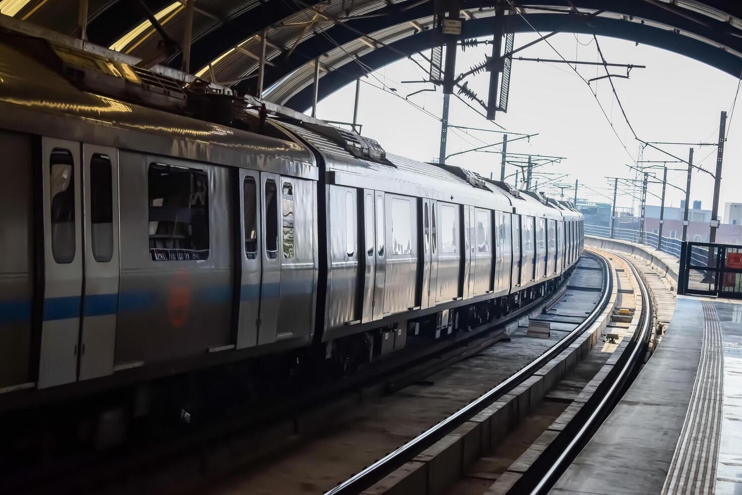 New Delhi, India, February 17 2024 - Delhi Metro train arriving at Jhandewalan metro station in New Delhi, India, Asia, Public Metro departing from Jhandewalan station photo