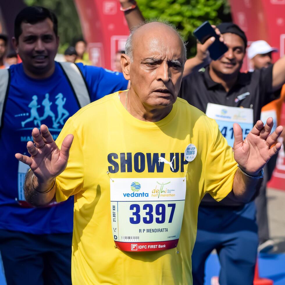 New Delhi, India - October 15 2023 - Vedanta Delhi Half Marathon race after covid in which marathon participants about to cross the finish line, Delhi Half Marathon 2023 photo