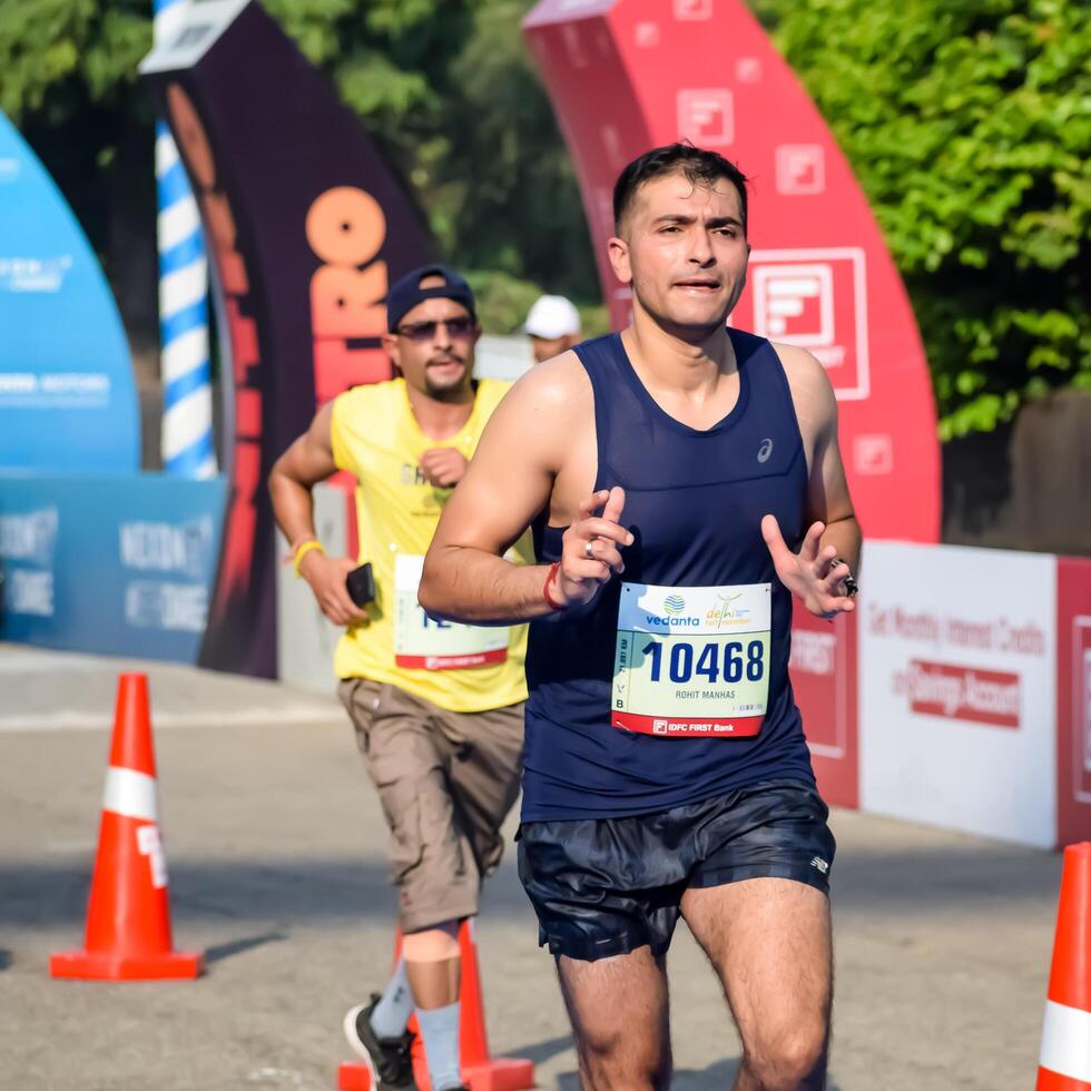 New Delhi, India - October 15 2023 - Vedanta Delhi Half Marathon race after covid in which marathon participants about to cross the finish line, Delhi Half Marathon 2023 photo