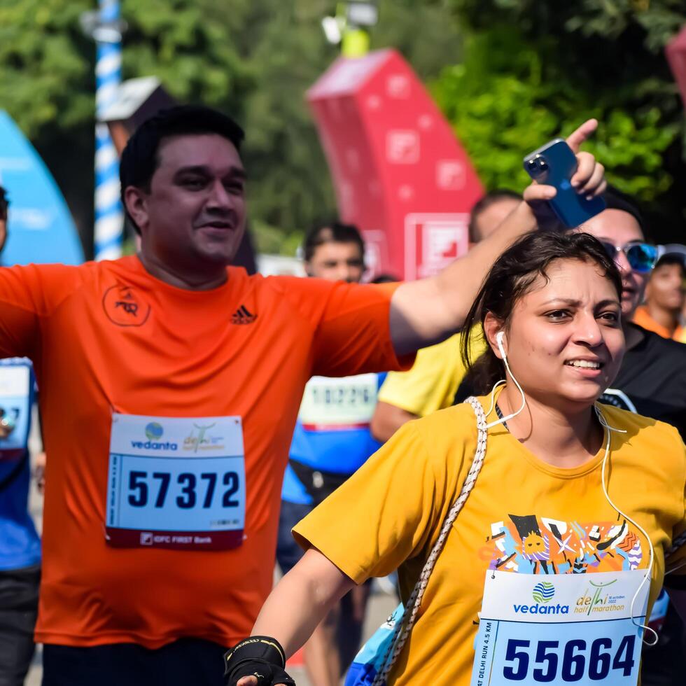 New Delhi, India - October 15 2023 - Vedanta Delhi Half Marathon race after covid in which marathon participants about to cross the finish line, Delhi Half Marathon 2023 photo
