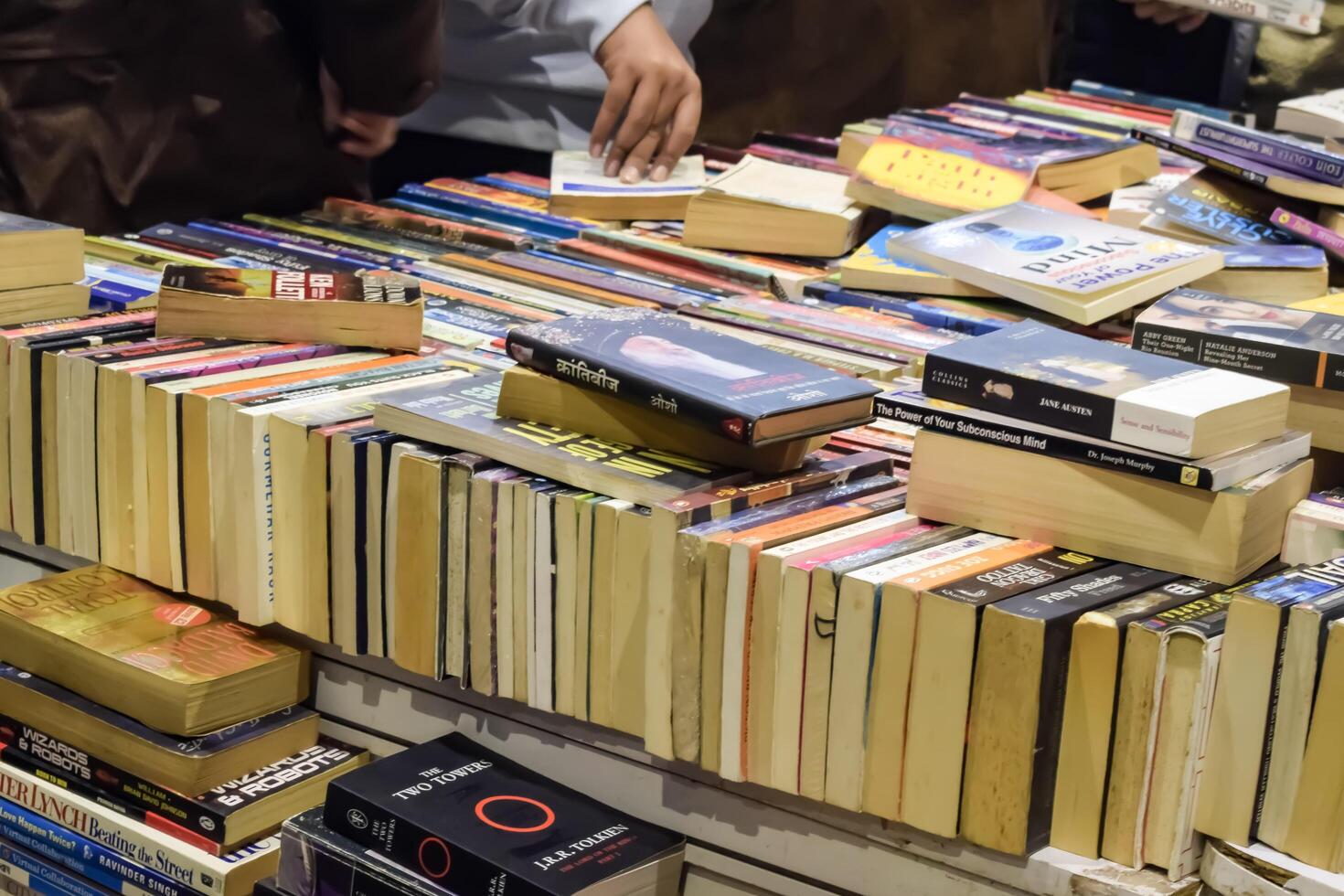 New Delhi, India, February 17 2024 - Variety of Books on shelf inside a book-stall at Delhi International Book Fair, Selection of books on display in Annual Book Fair at Bharat Mandapam complex photo
