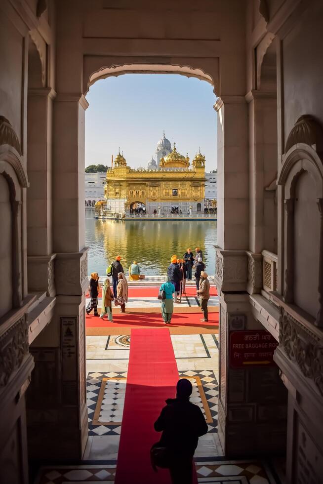 Amritsar, India - February 26 2024 -Unidentified devotees from various parts at Golden Temple - Harmandir Sahib in Amritsar, Punjab, India, Famous indian sikh landmark, Golden Temple photo