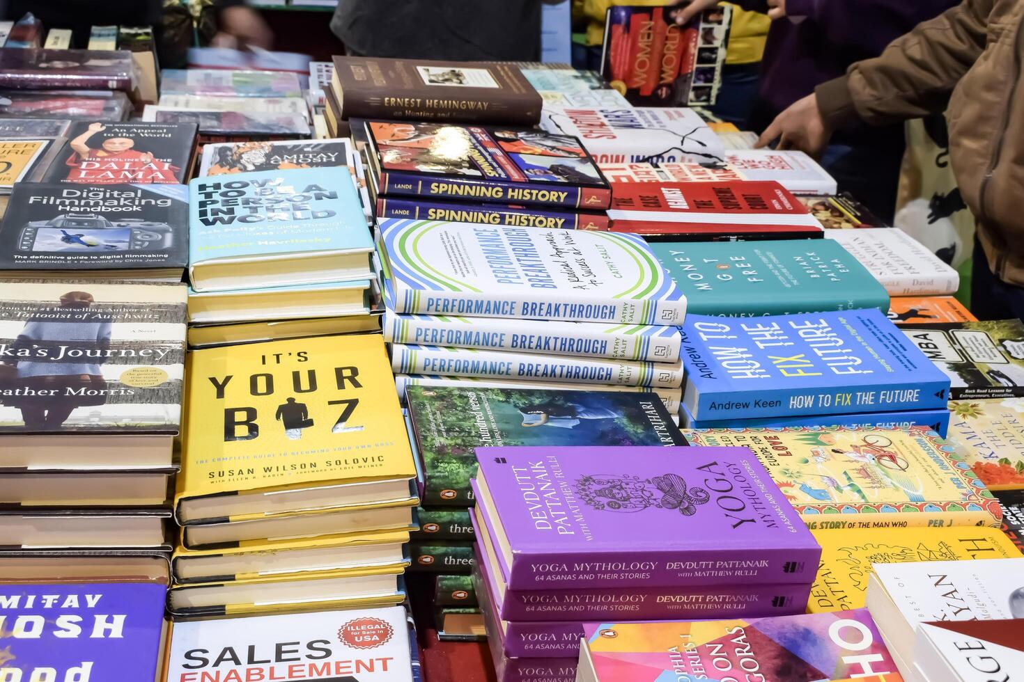 New Delhi, India, February 17 2024 - Variety of Books on shelf inside a book-stall at Delhi International Book Fair, Selection of books on display in Annual Book Fair at Bharat Mandapam complex photo