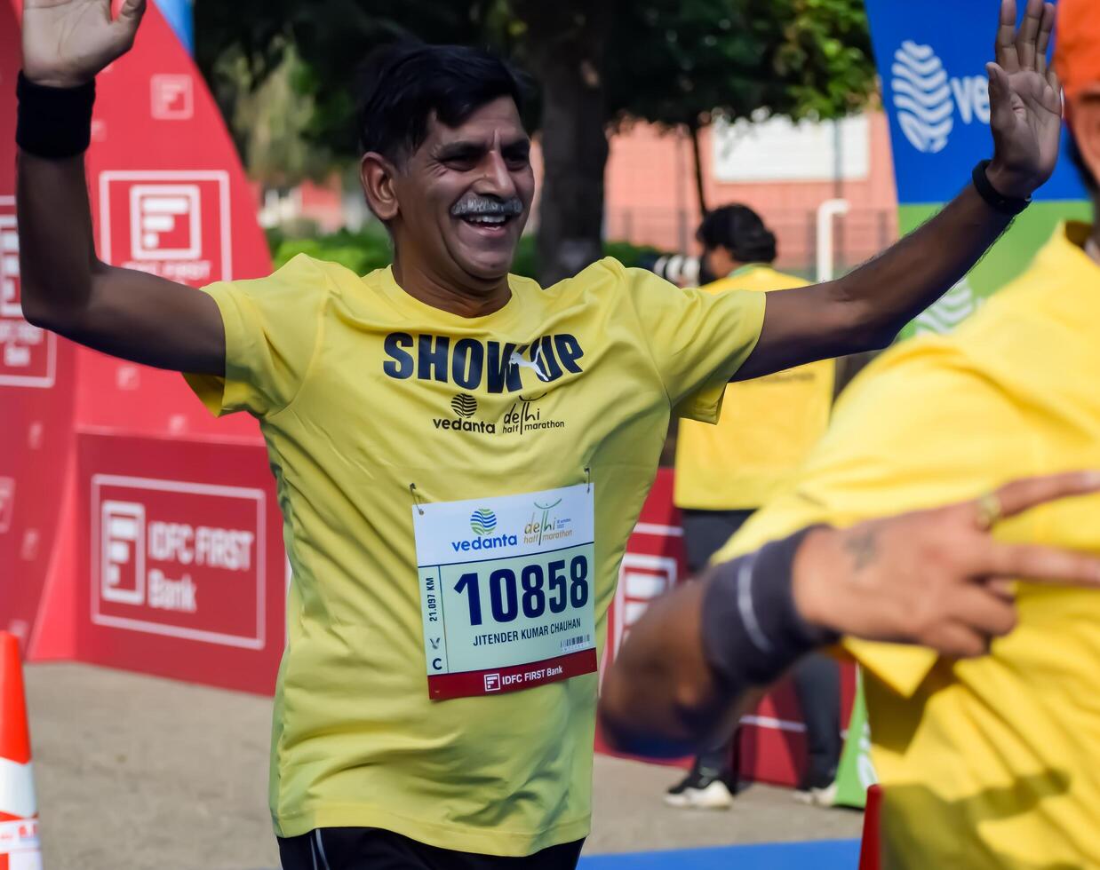 New Delhi, India - October 15 2023 - Vedanta Delhi Half Marathon race after covid in which marathon participants about to cross the finish line, Delhi Half Marathon 2023 photo