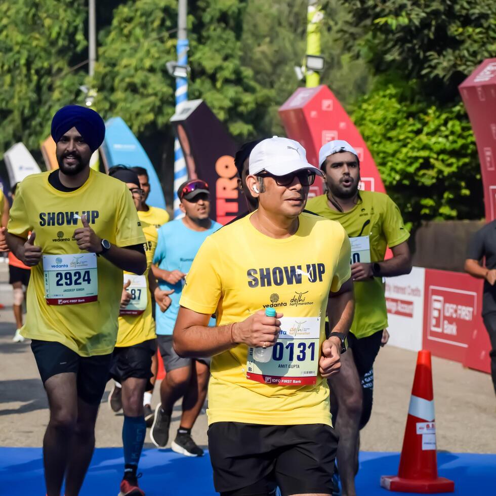 New Delhi, India - October 15 2023 - Vedanta Delhi Half Marathon race after covid in which marathon participants about to cross the finish line, Delhi Half Marathon 2023 photo