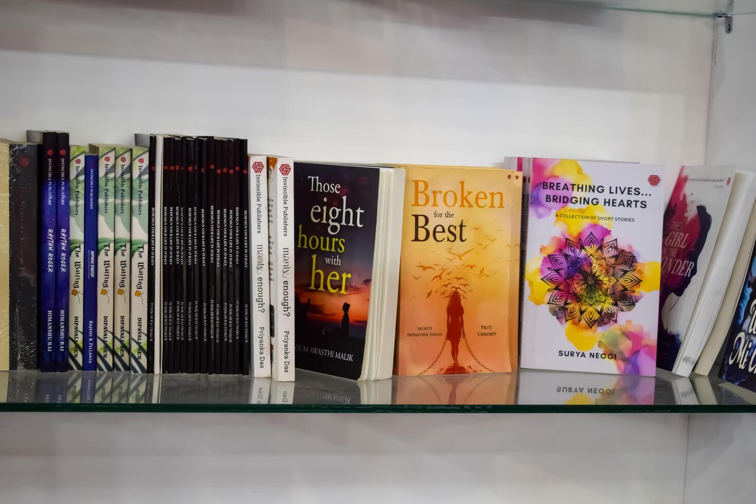 New Delhi, India, February 17 2024 - Variety of Books on shelf inside a book-stall at Delhi International Book Fair, Selection of books on display in Annual Book Fair at Bharat Mandapam complex photo