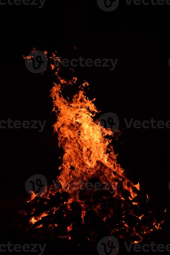 Fire flames on black background, Blaze fire flame texture background, Beautifully, the fire is burning, Fire flames with wood and cow dung bonfire photo