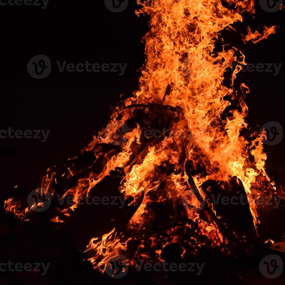 Fire flames on black background, Blaze fire flame texture background, Beautifully, the fire is burning, Fire flames with wood and cow dung bonfire photo