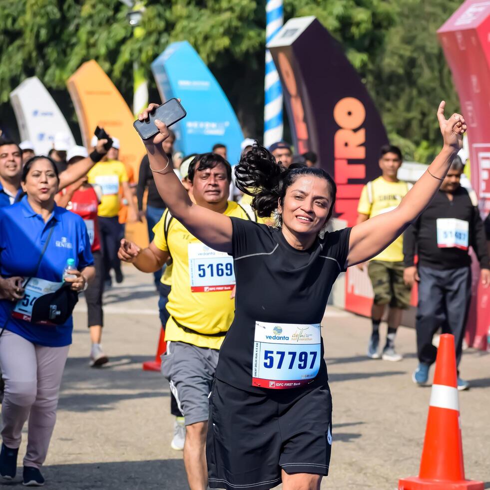 New Delhi, India - October 15 2023 - Vedanta Delhi Half Marathon race after covid in which marathon participants about to cross the finish line, Delhi Half Marathon 2023 photo