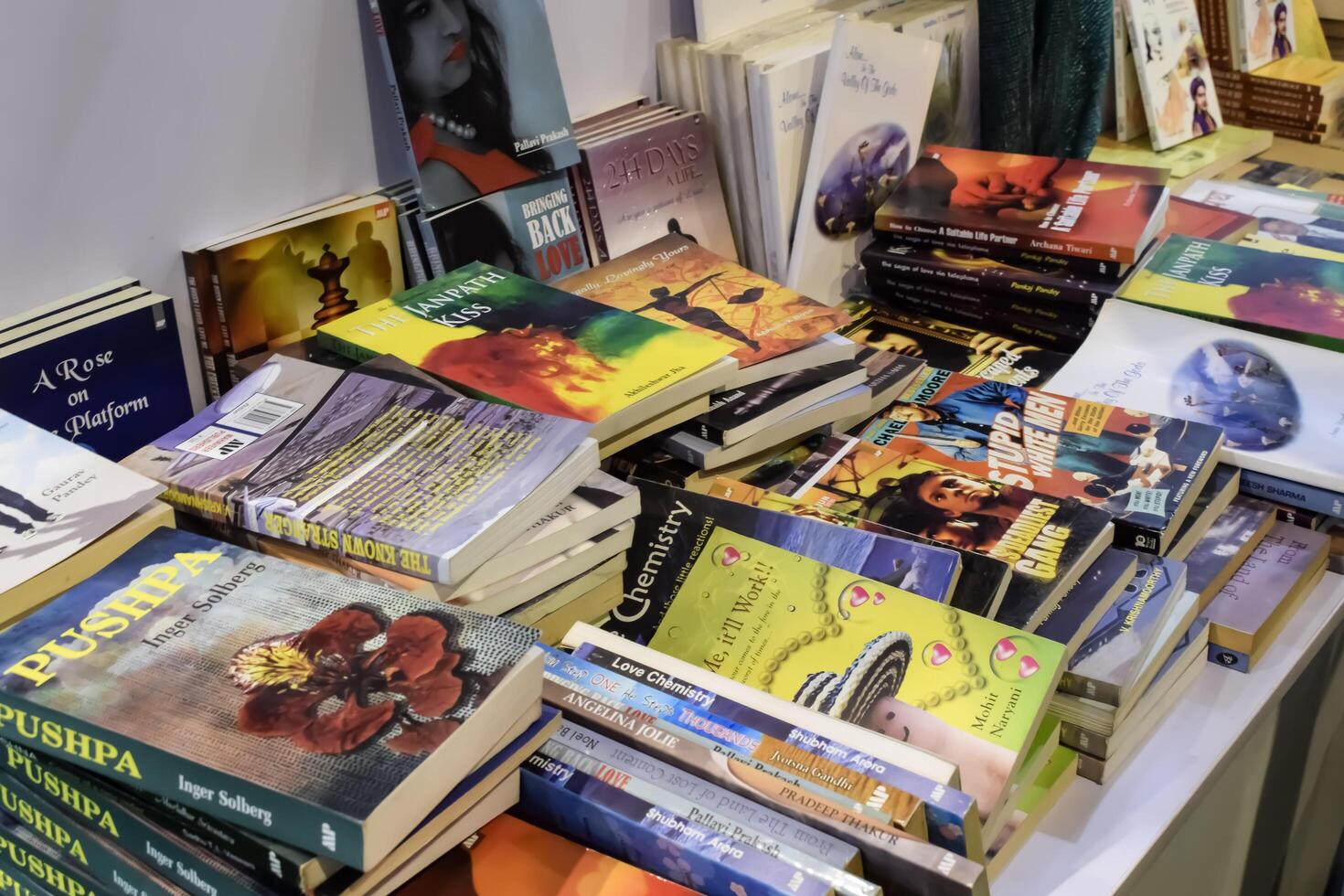 New Delhi, India, February 17 2024 - Variety of Books on shelf inside a book-stall at Delhi International Book Fair, Selection of books on display in Annual Book Fair at Bharat Mandapam complex photo