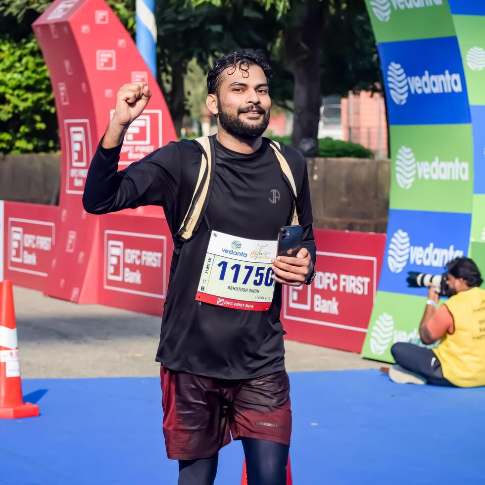 New Delhi, India - October 15 2023 - Vedanta Delhi Half Marathon race after covid in which marathon participants about to cross the finish line, Delhi Half Marathon 2023 photo