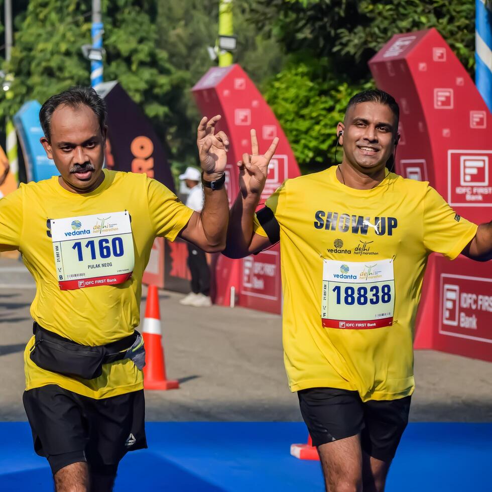 New Delhi, India - October 15 2023 - Vedanta Delhi Half Marathon race after covid in which marathon participants about to cross the finish line, Delhi Half Marathon 2023 photo