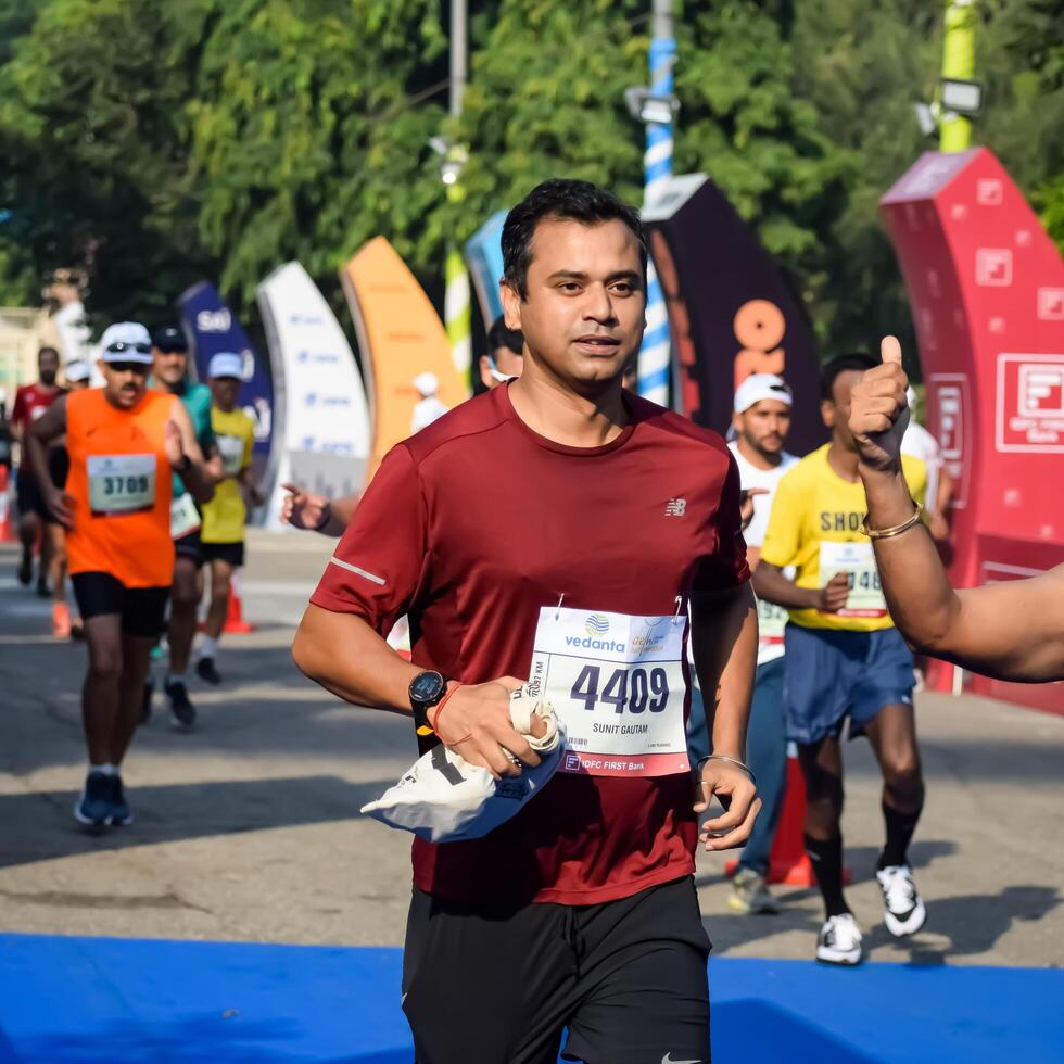 New Delhi, India - October 15 2023 - Vedanta Delhi Half Marathon race after covid in which marathon participants about to cross the finish line, Delhi Half Marathon 2023 photo