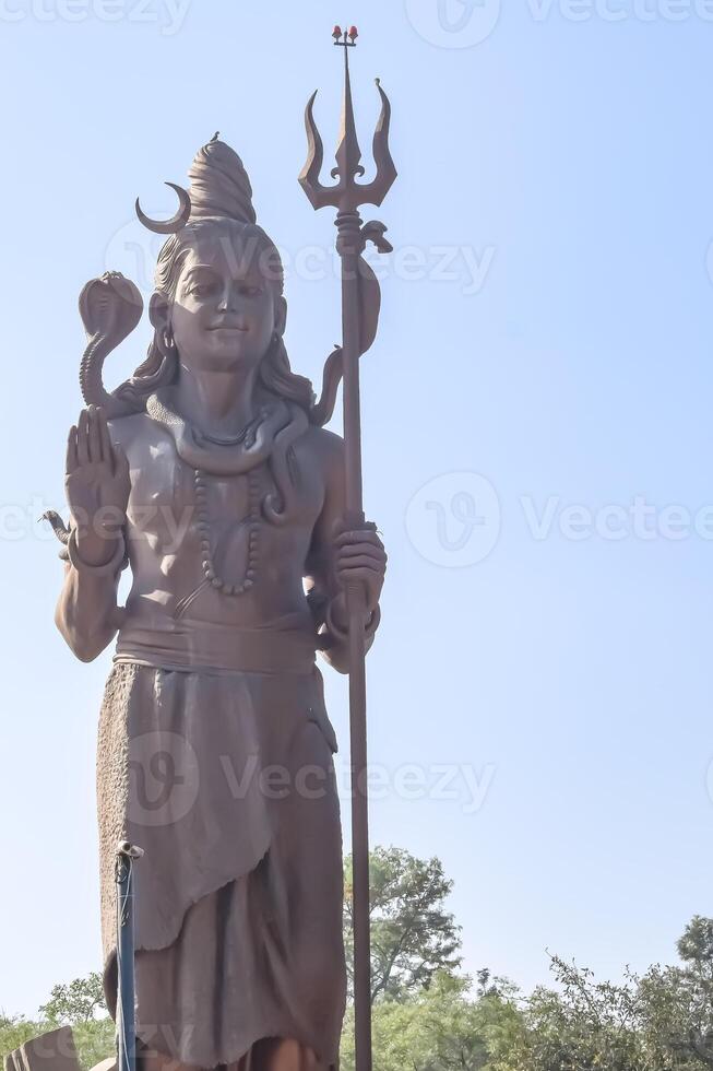 Big statue of Lord Shiva near Delhi International airport, Delhi, India, Lord Shiv big statue touching sky at main highway Mahipalpur, Delhi photo