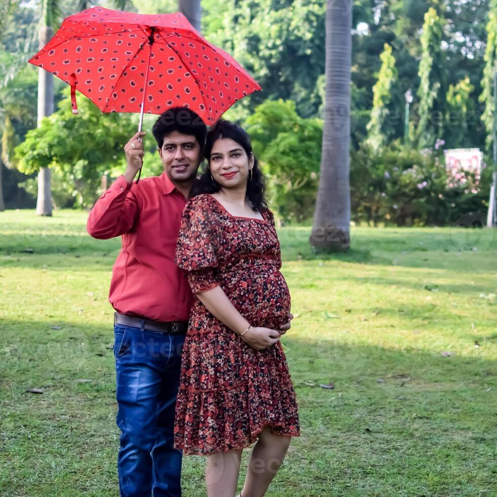 Indian couple posing for Maternity shoot pose for welcoming new born baby in Lodhi Garden in Delhi India, Maternity photo shoot done by parents for welcoming their child, Pre Baby Photo Shoot