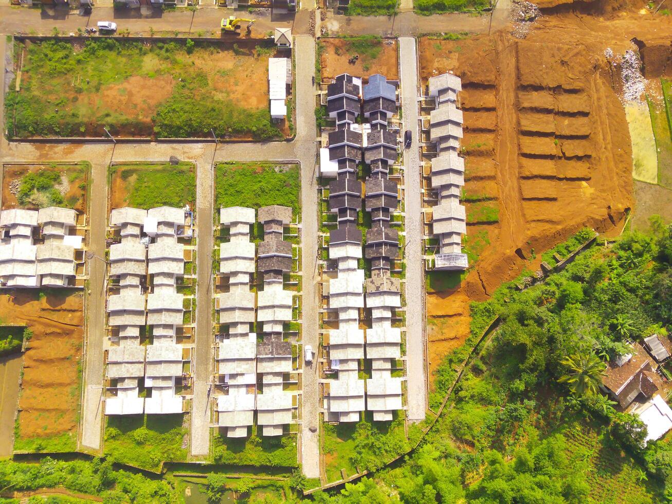 White roofed housing. Geometric aerial drone view of residential district in Bandung City - Indonesia. Housing industry. Above. Social Issues. Shot from drone flying 100 meters photo