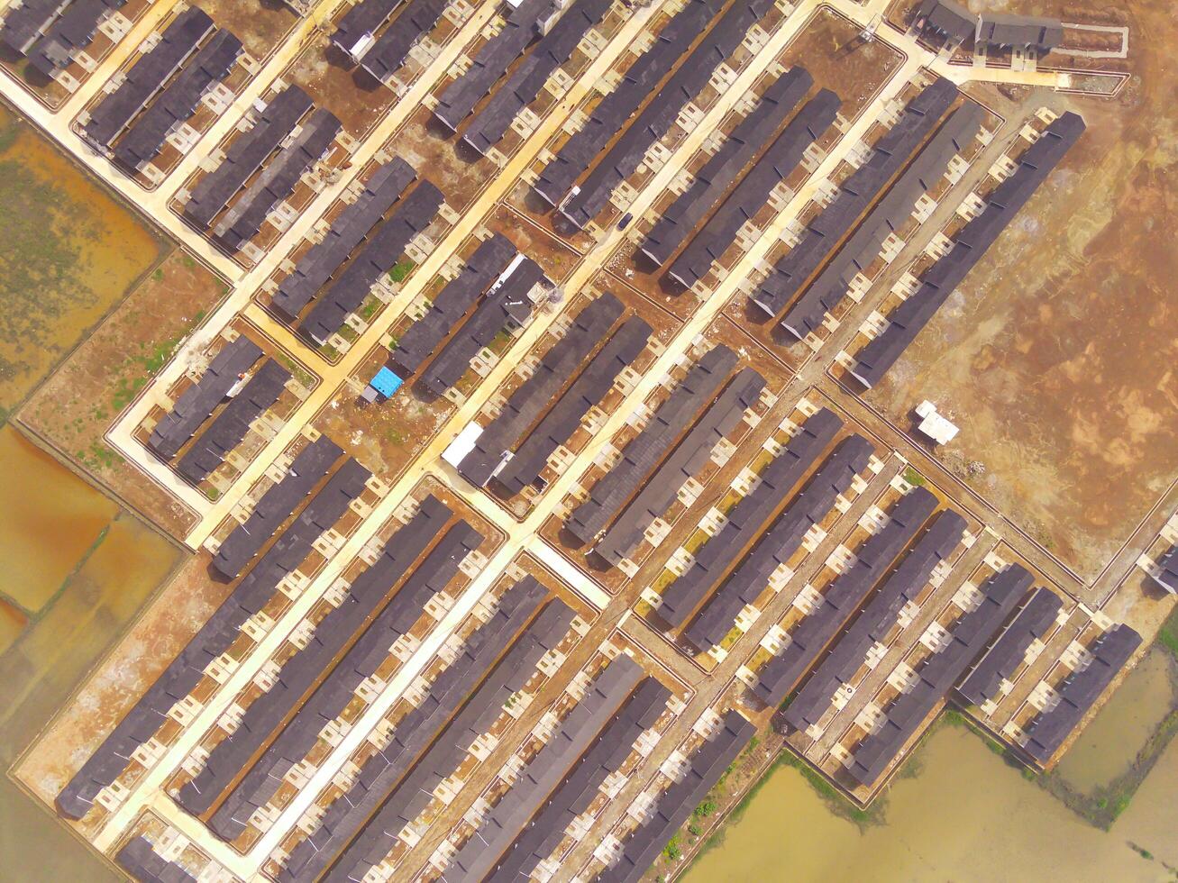 Public houses in Bandung City from drone. Aerial drone view of public housing on the edge of the city. View from above, Housing Development. Above. Social issues. Shot from drone flying 100 meters photo