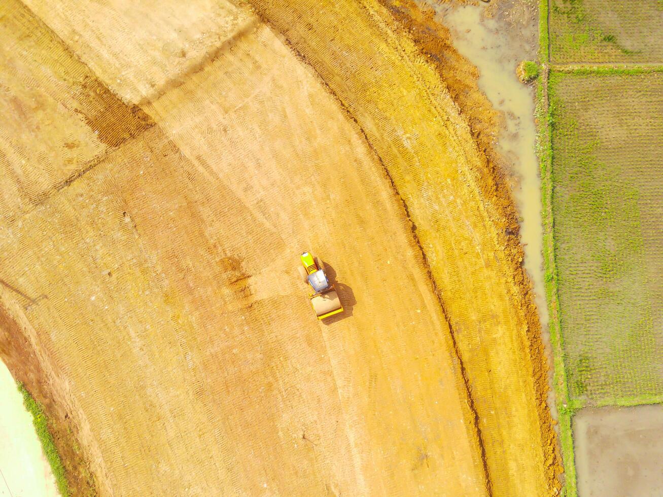 Heavy equipment vehicles are leveling the ground. Aerial drone view of Housing development on the edge of the city. View from above, Housing Industry. Above. Social issues. Shot from drone flying photo