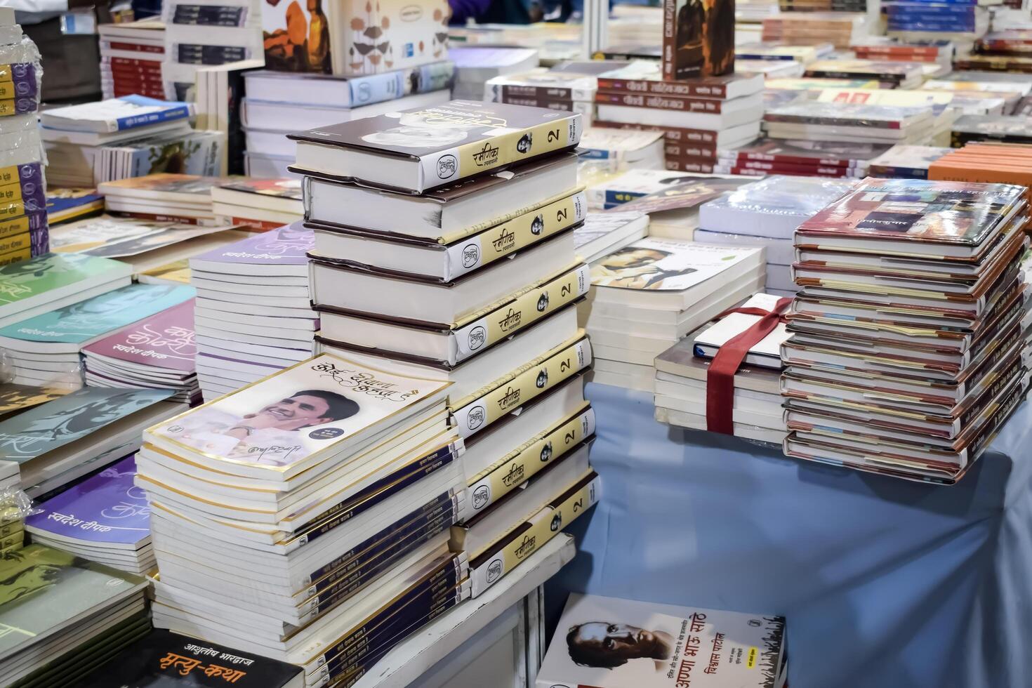 New Delhi, India, February 17 2024 - Variety of Books on shelf inside a book-stall at Delhi International Book Fair, Selection of books on display in Annual Book Fair at Bharat Mandapam complex photo